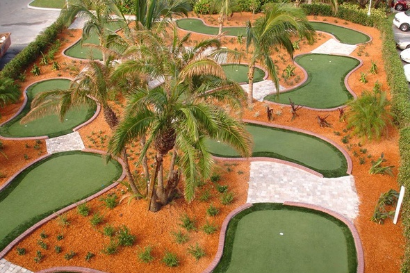 Tucson Aerial view of a mini golf course with synthetic grass and palm trees.
